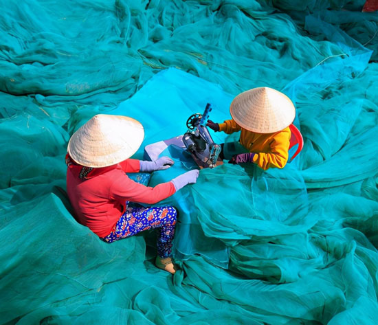 Vietnamese Women Sewing Fishing Net